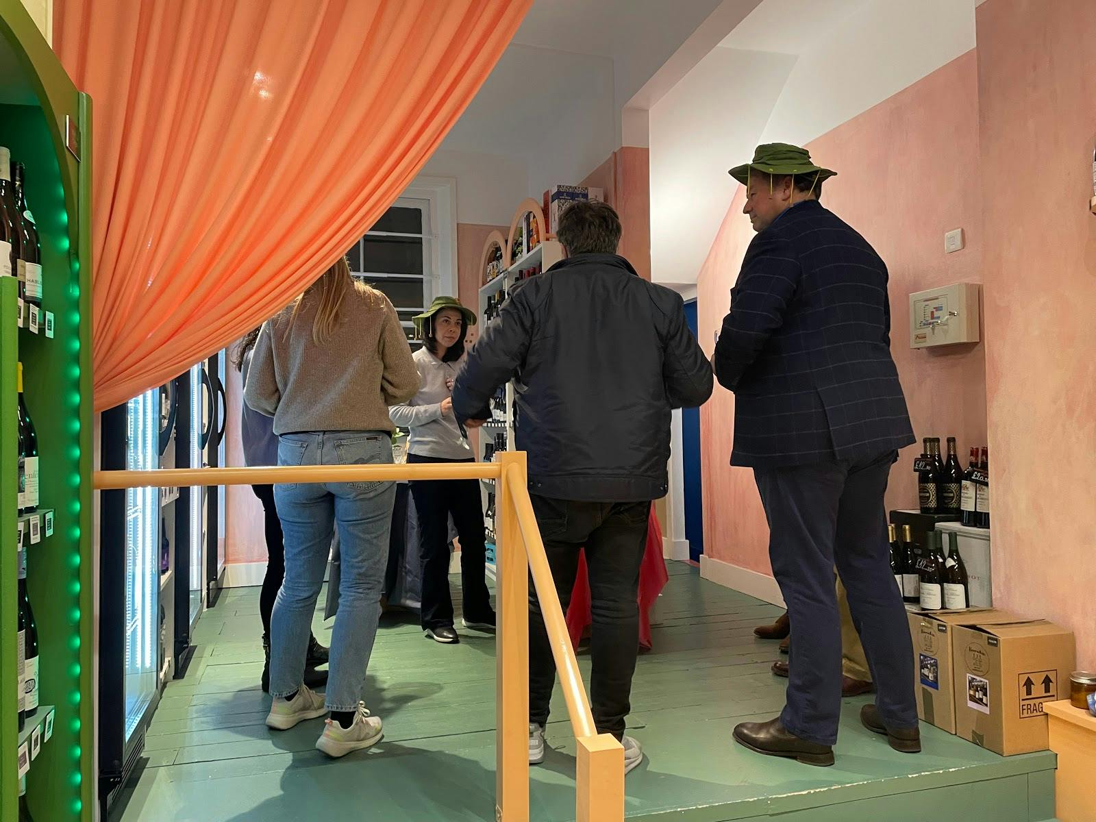 PEYRAUTINS PINOT NOIR tasting event in a vibrant, inviting space with colorful decor.