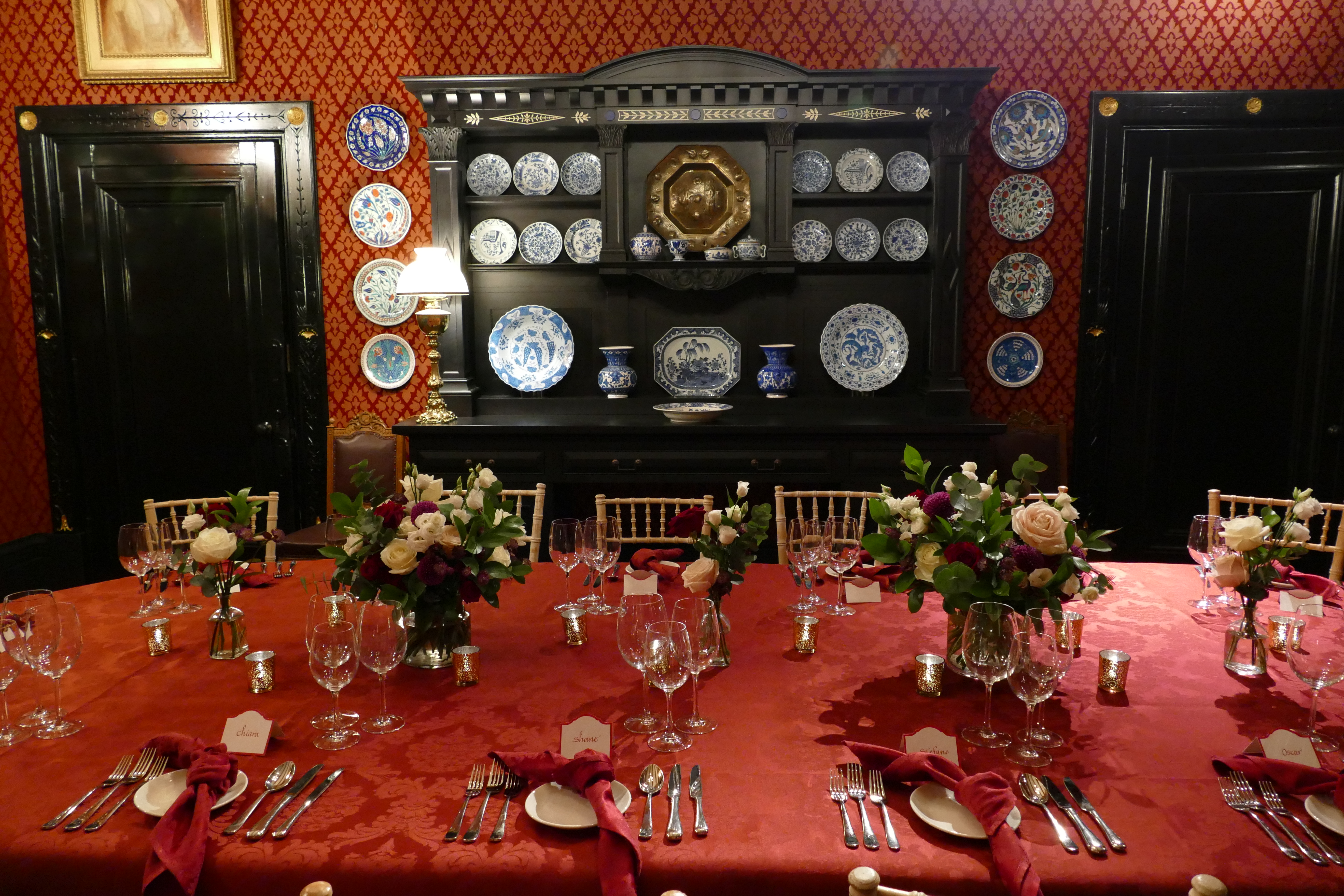 Elegant dining room at Leighton House with red tablecloth, ideal for formal events.