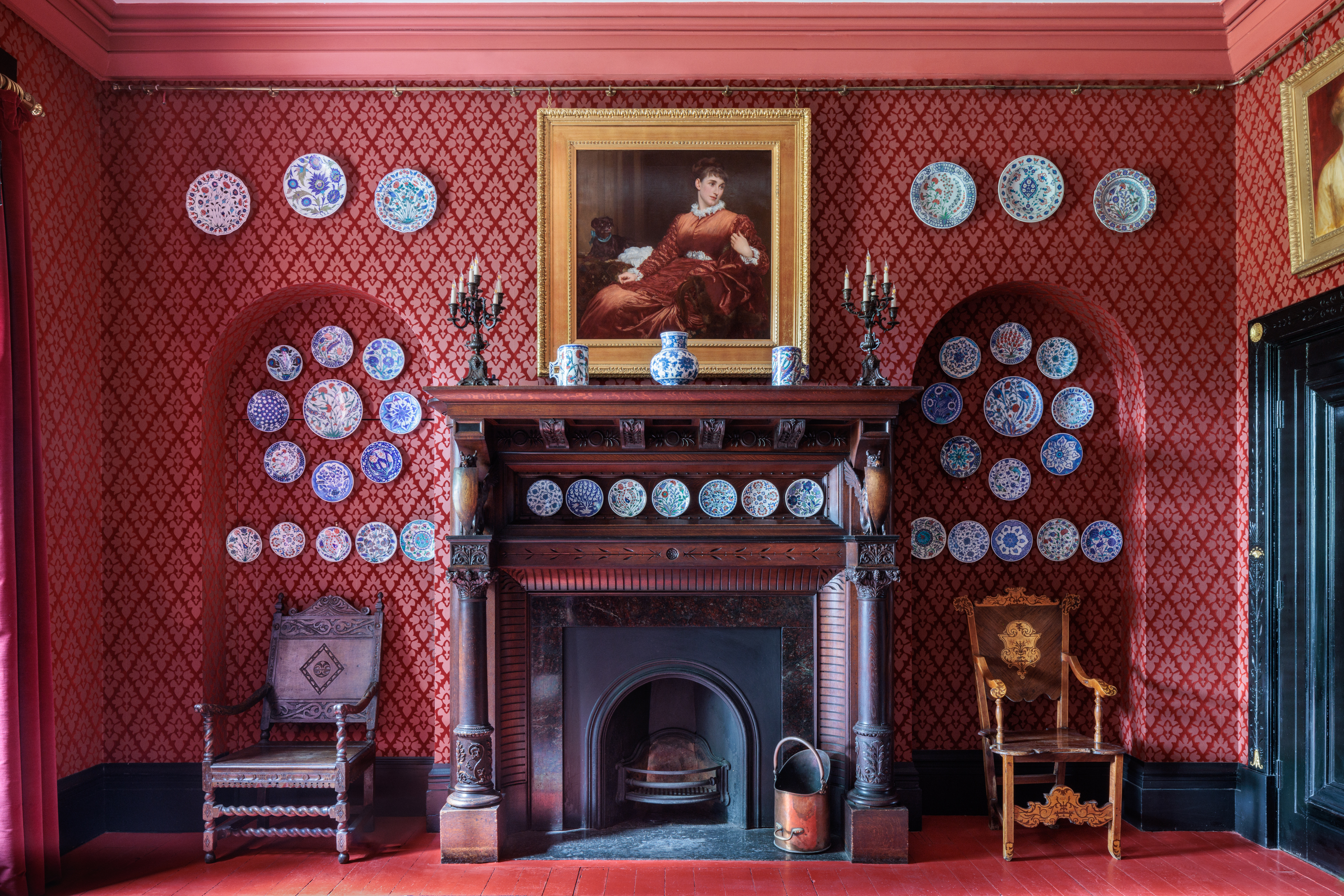 Dining room at Leighton House with red wallpaper, perfect for upscale events and gatherings.