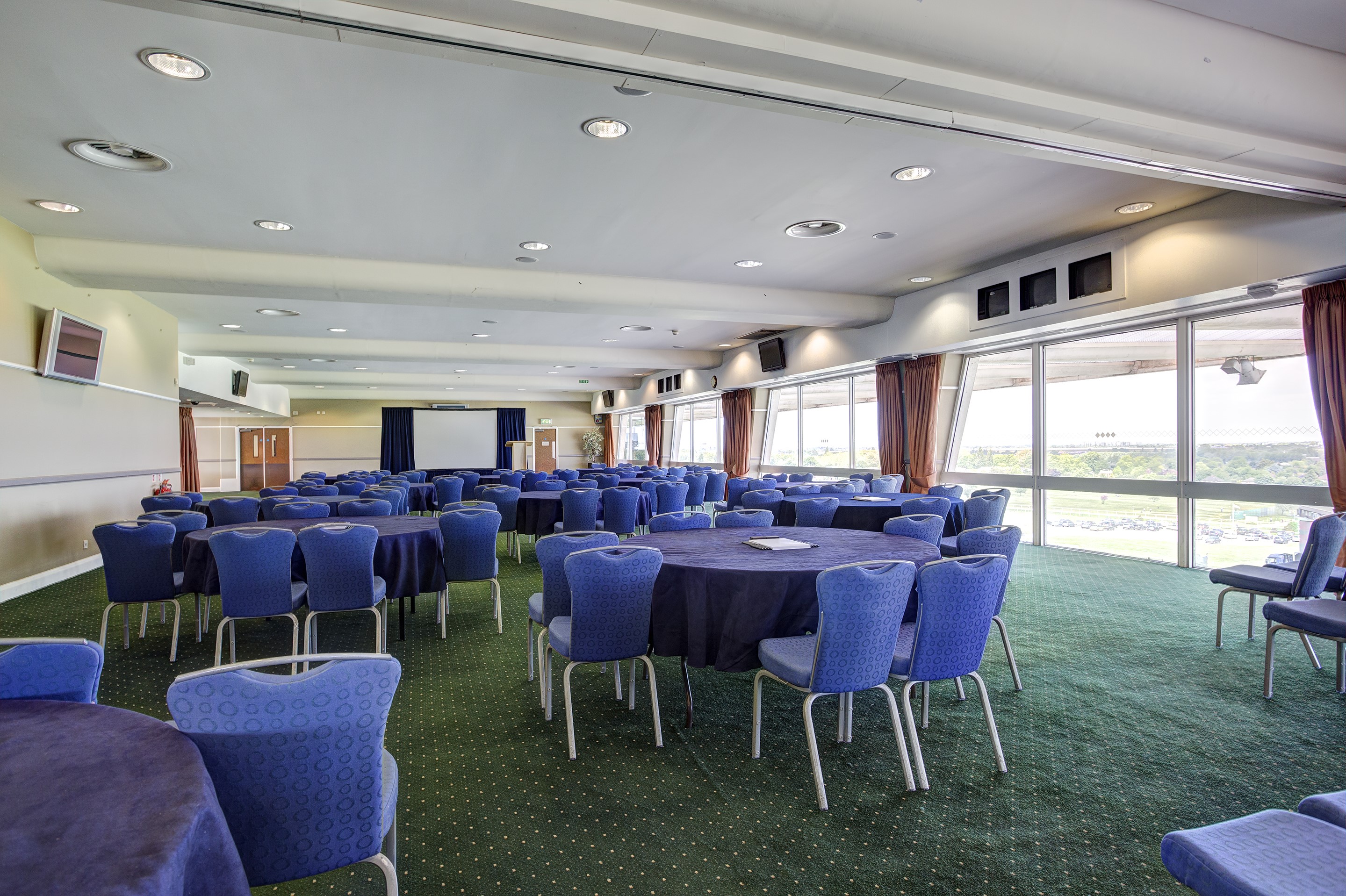 Gold Cup Suite at Sandown Park: spacious venue with round tables for meetings and banquets.