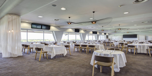 Elegant event venue at Sandown Park Racecourse with round tables for corporate gatherings.