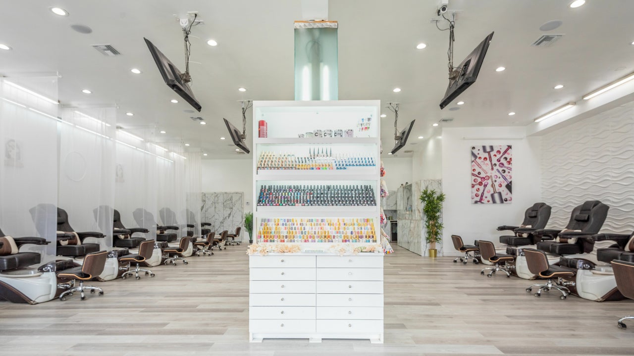 Modern nail salon with vibrant polish display, ideal for beauty workshops and retreats.