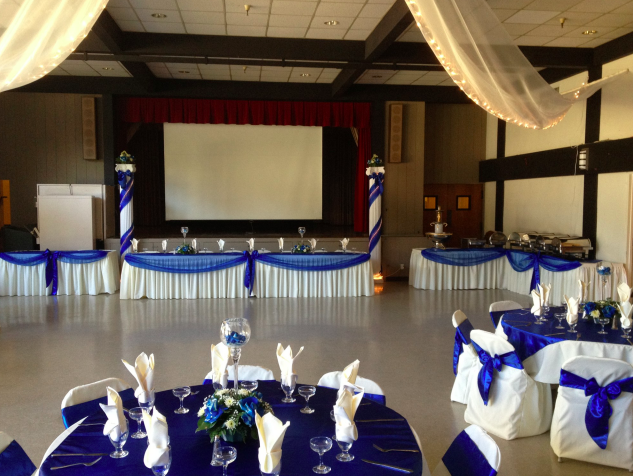Elegant auditorium with blue and white drapery, perfect for weddings and corporate events.