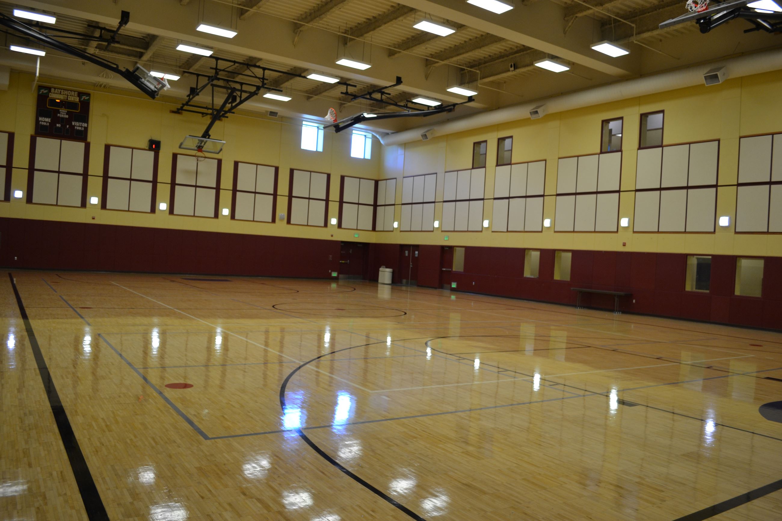 Bayshore Community Center gym with polished floors, ideal for sports and events.