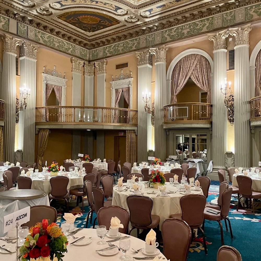 Elegant Crystal Ballroom with round tables, ideal for weddings and corporate events.