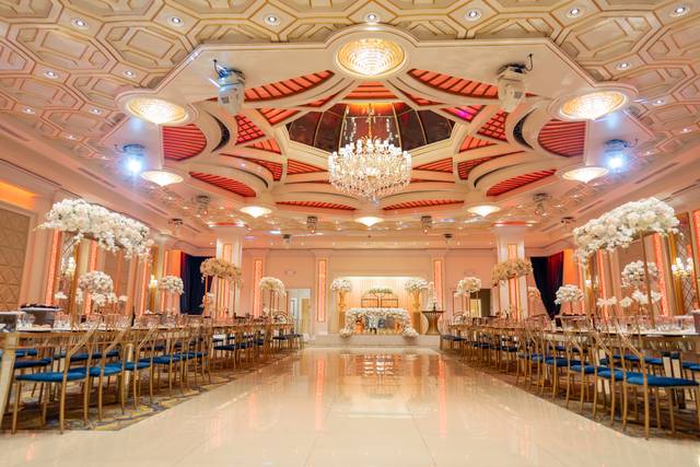 Elegant banquet hall with grand chandelier, perfect for weddings and corporate events.