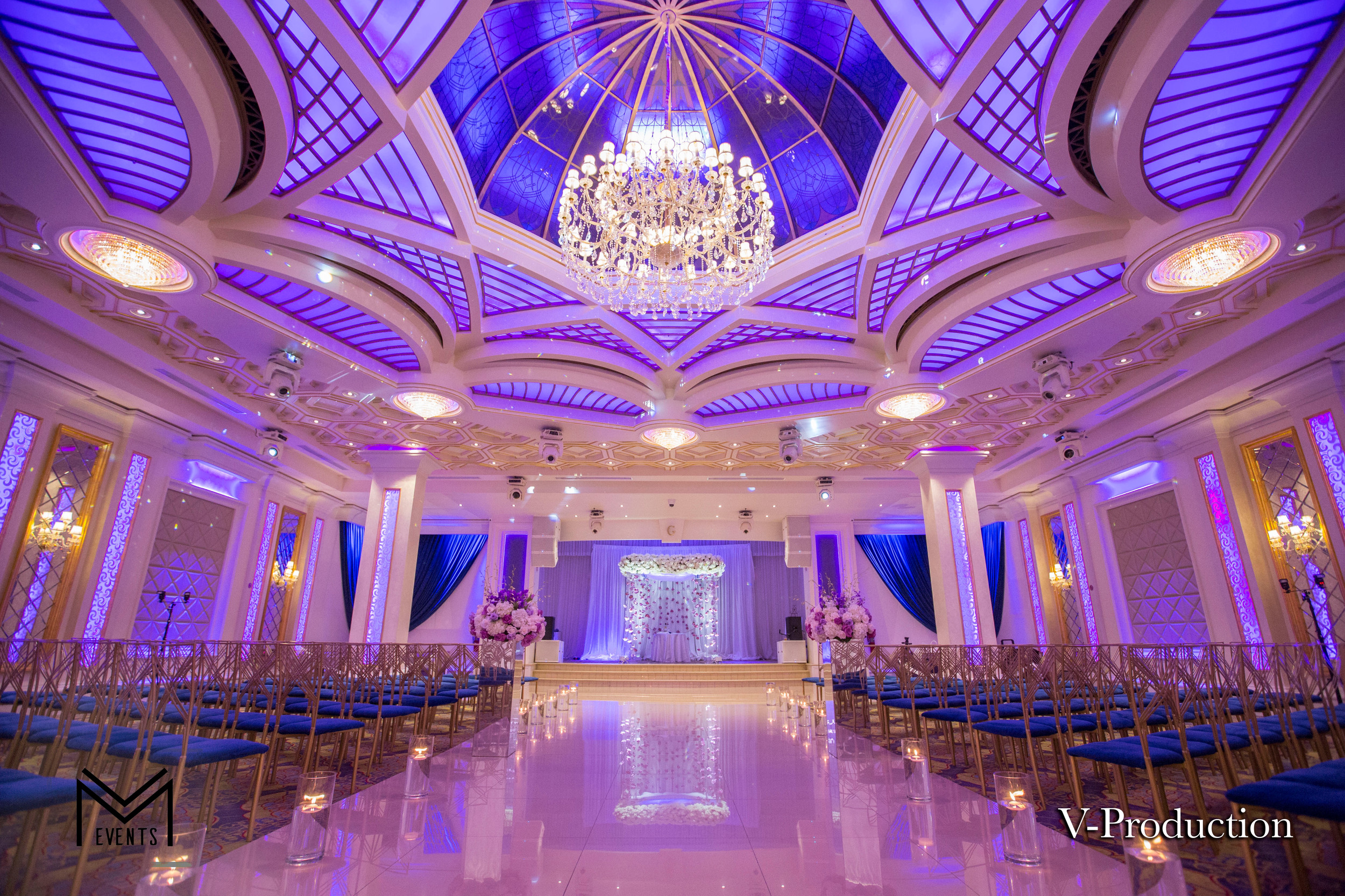 Elegant banquet hall with chandeliers, perfect for weddings and formal gatherings.