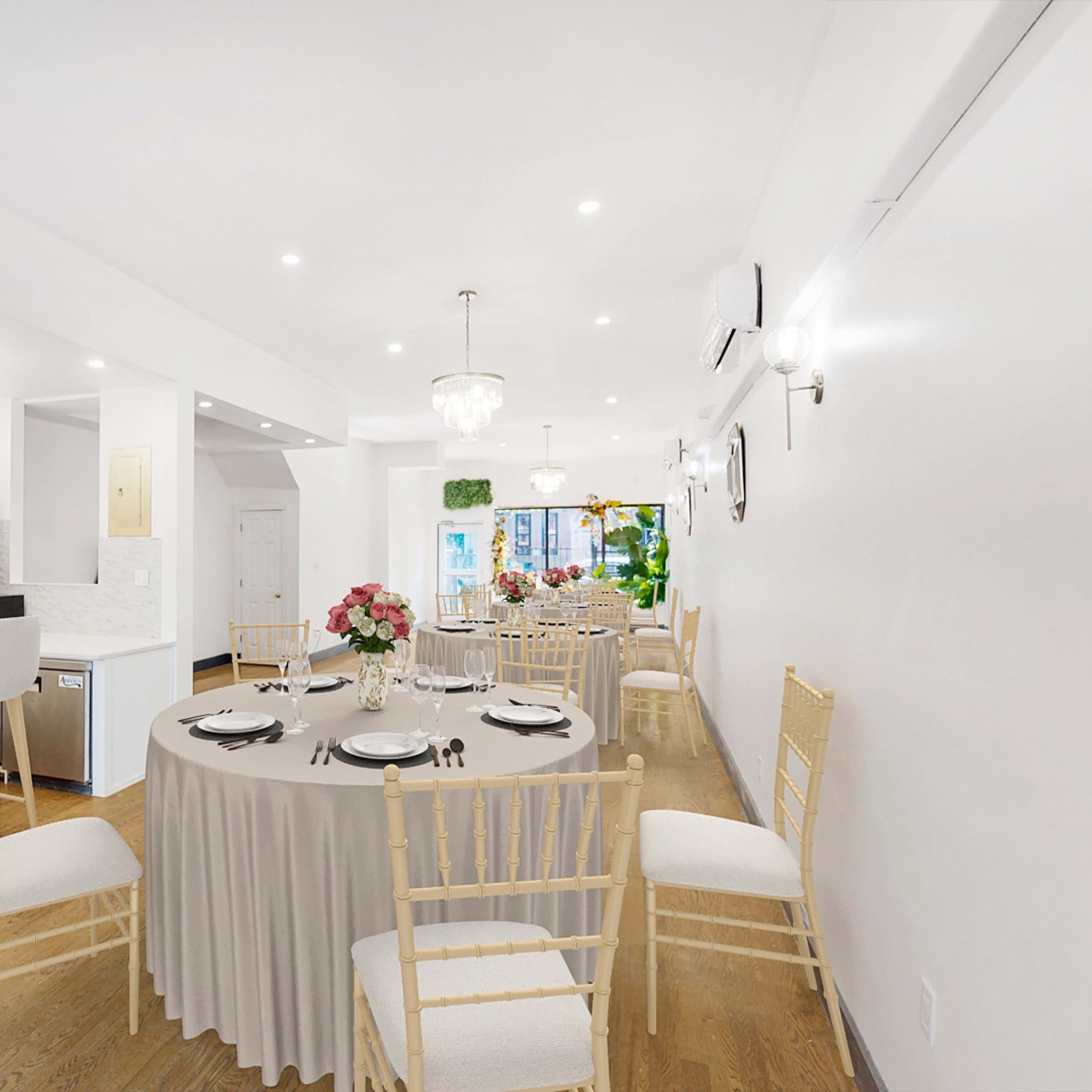 Elegant private dinner setup with floral centerpieces in a bright event space.