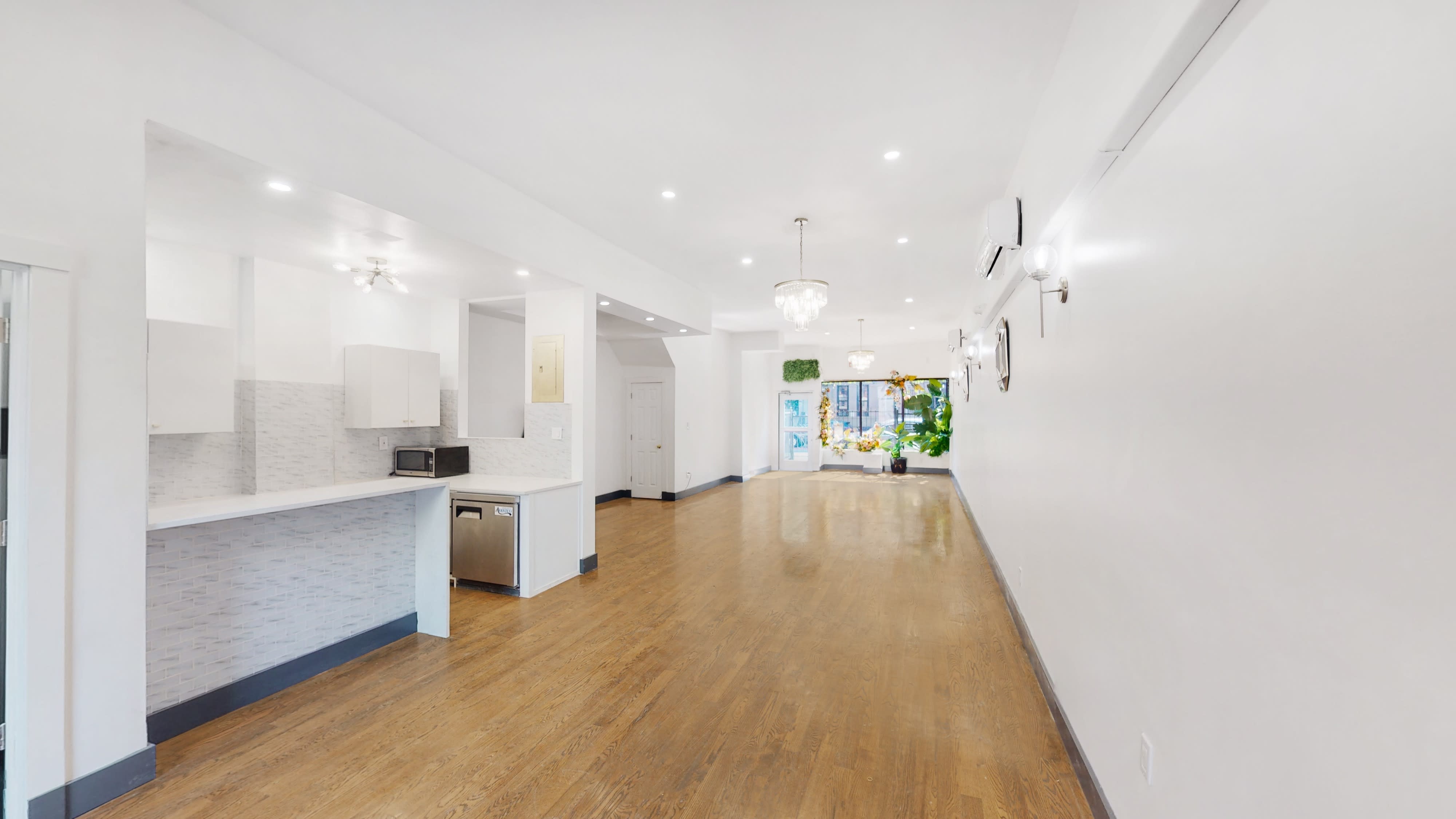 Spacious event space with polished floors for intimate gatherings and meetings.