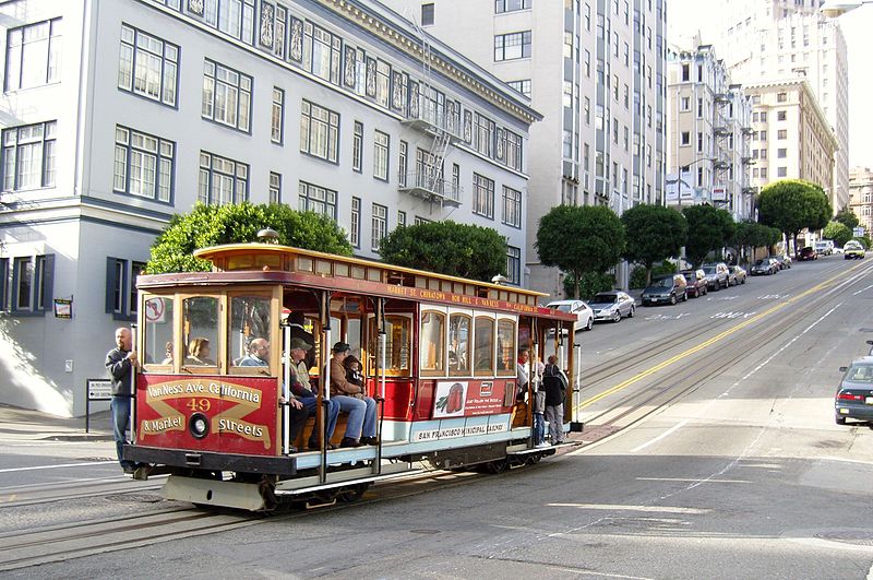 Classic cable car on steep San Francisco street, perfect for event excursions and photos.