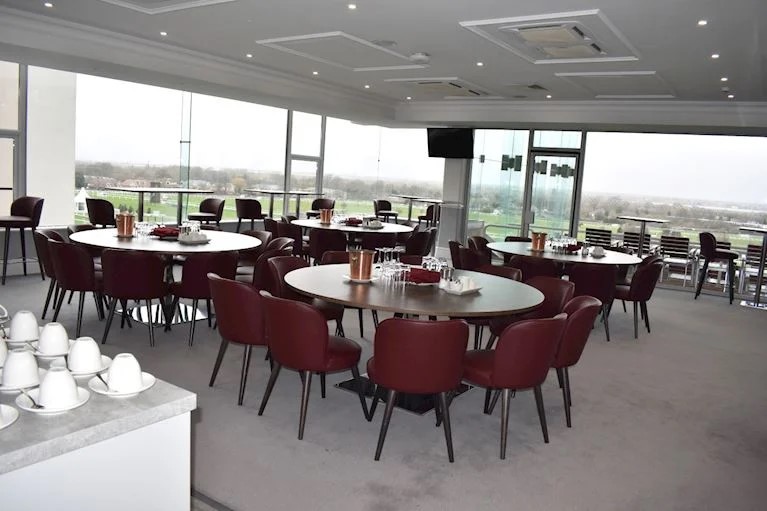 Royal Box at Sandown Park Racecourse, elegant tables set for corporate events and workshops.