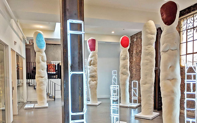 Art gallery with tall abstract sculptures, perfect for creative events and exhibitions.