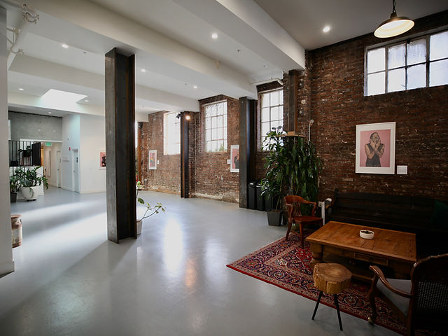 Art gallery event space with exposed brick, ideal for workshops and networking.