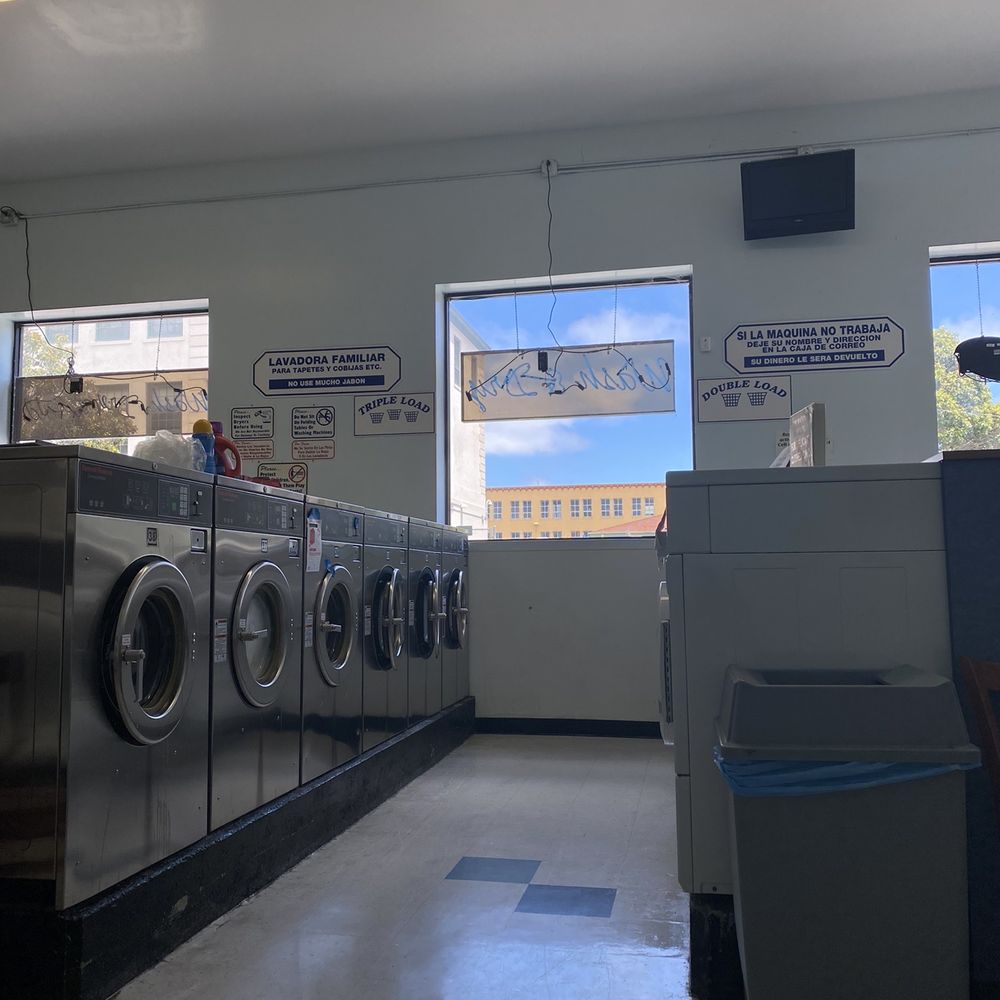 Modern laundromat with natural light, ideal for casual networking events and workshops.