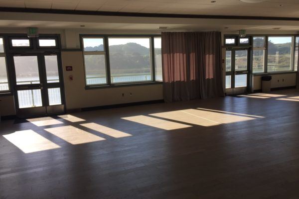 Spacious Lake Merced Boathouse venue with large windows for events and receptions.