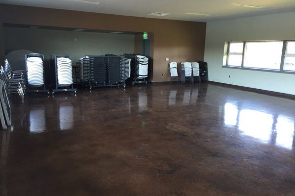 Versatile event space with polished concrete floor at Lake Merced Boathouse for meetings.