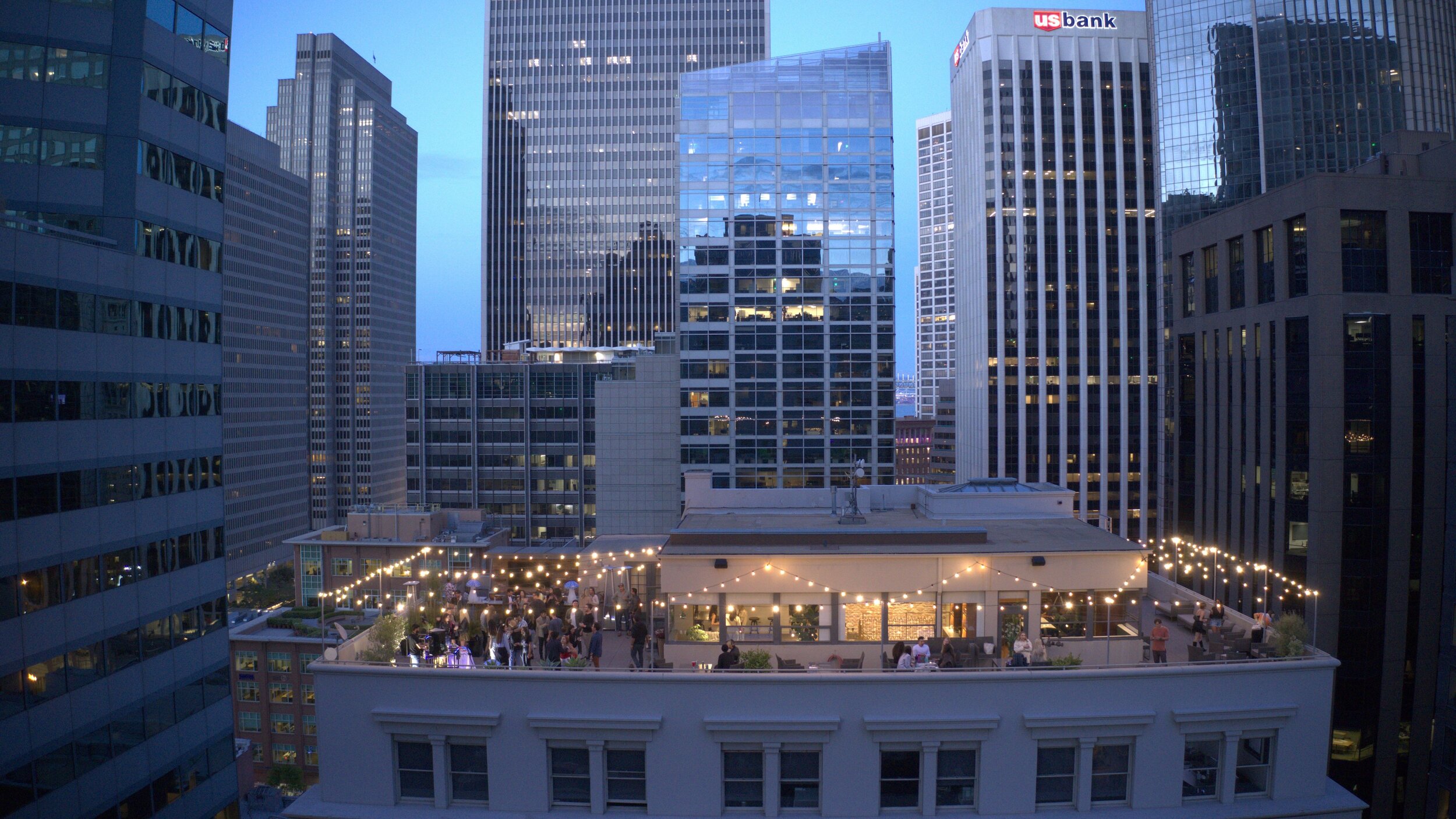 Rooftop patio with string lights, perfect for urban networking events and receptions.