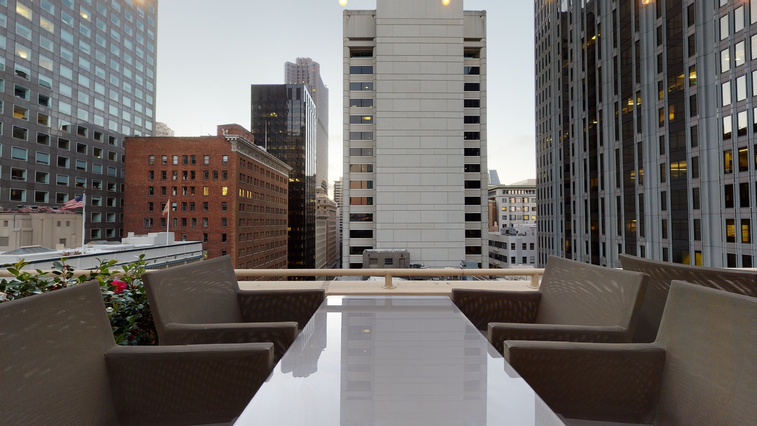 Rooftop patio with modern seating, perfect for networking events in the city.