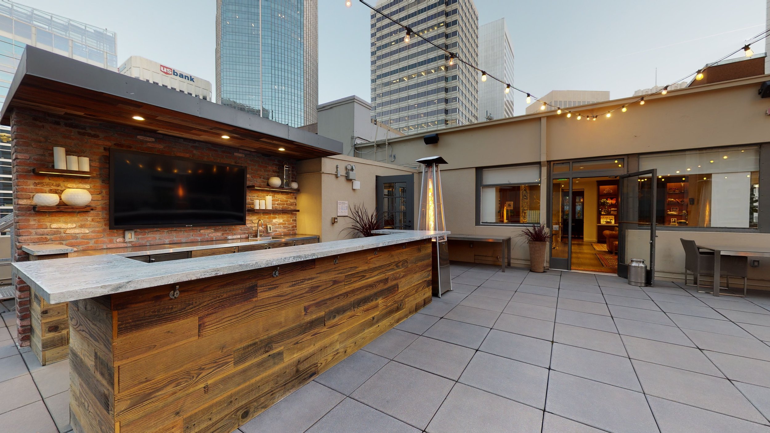 Stylish rooftop patio with modern bar, ideal for networking events and cocktail receptions.