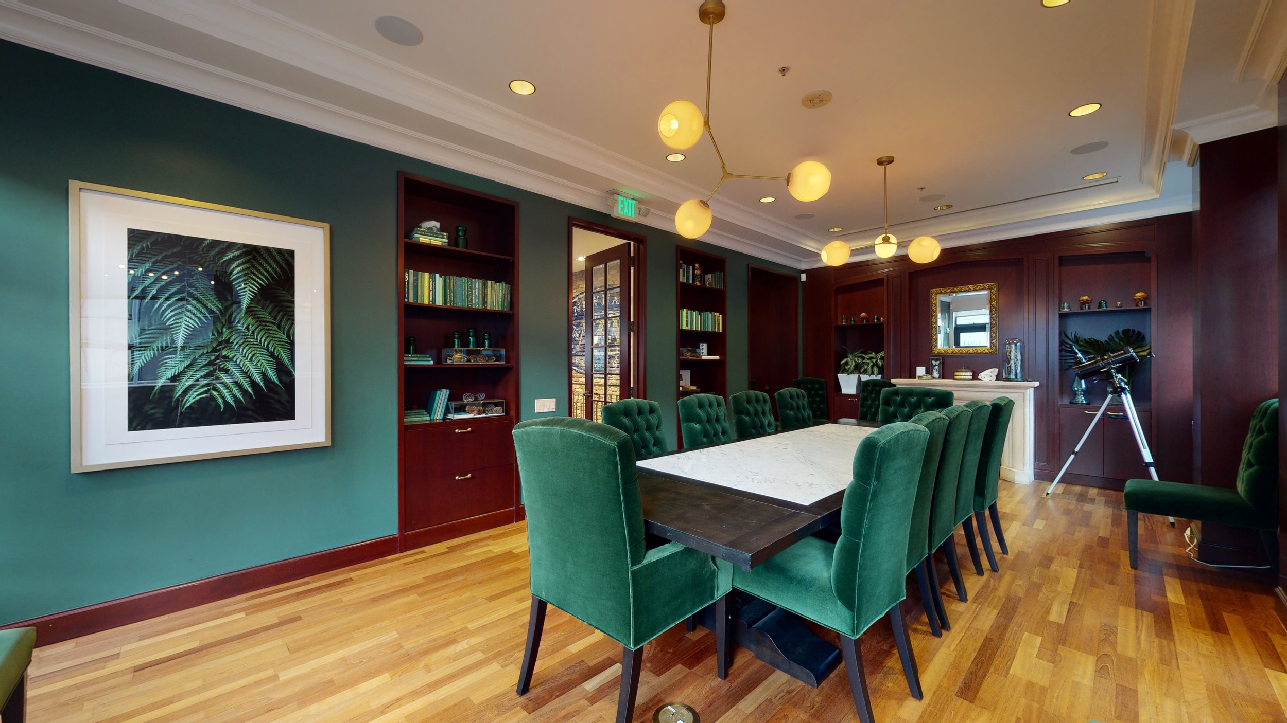 Stylish conference room with green accents for intimate meetings and brainstorming sessions.