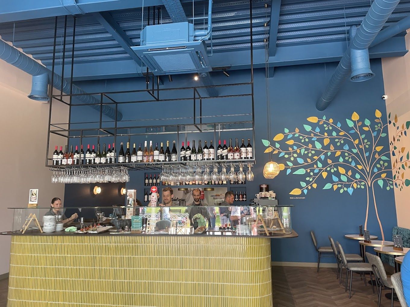 Vibrant bar area with mural, ideal for networking events and casual gatherings.