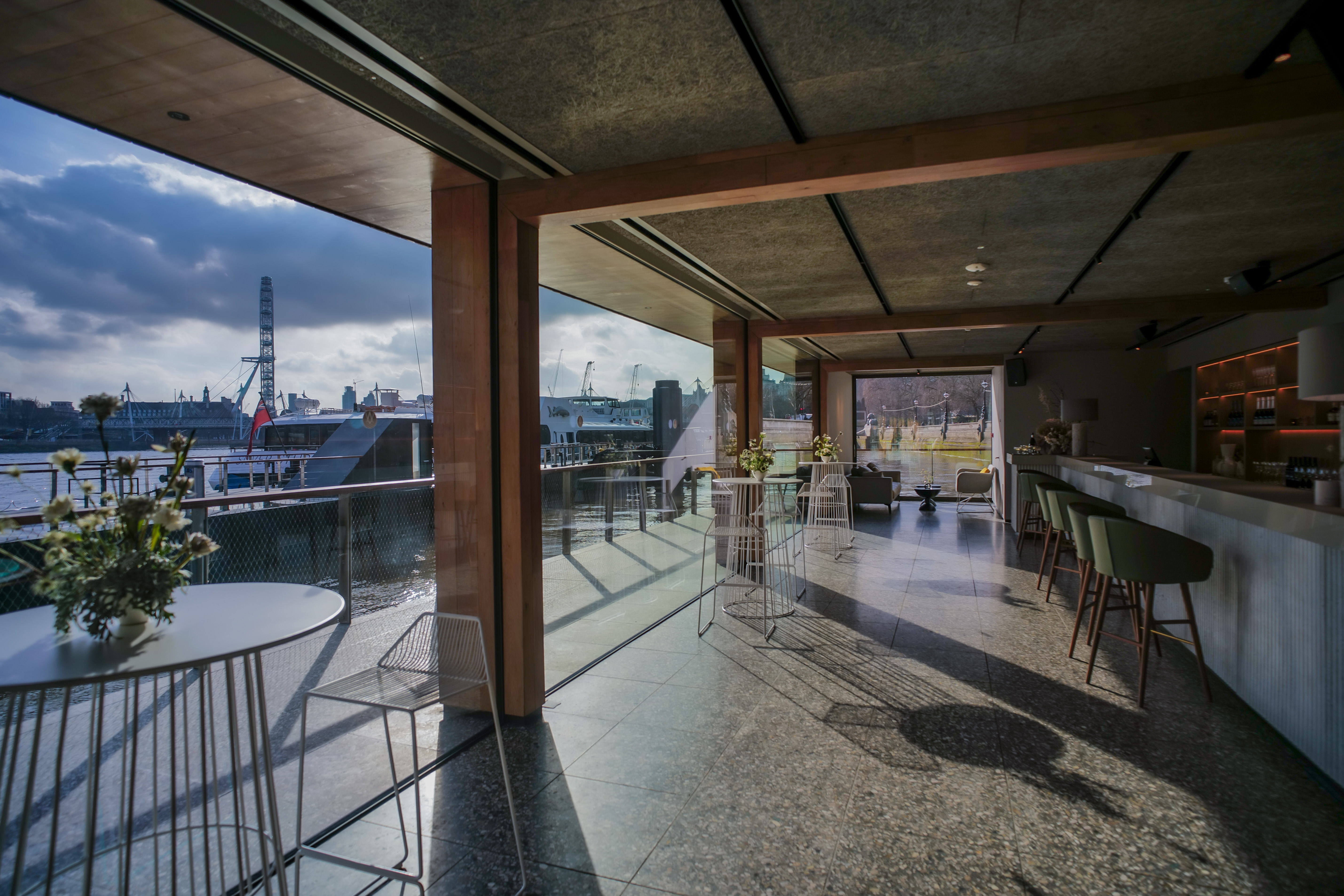 Modern event space at Woods Quay with waterfront view, ideal for meetings and gatherings.