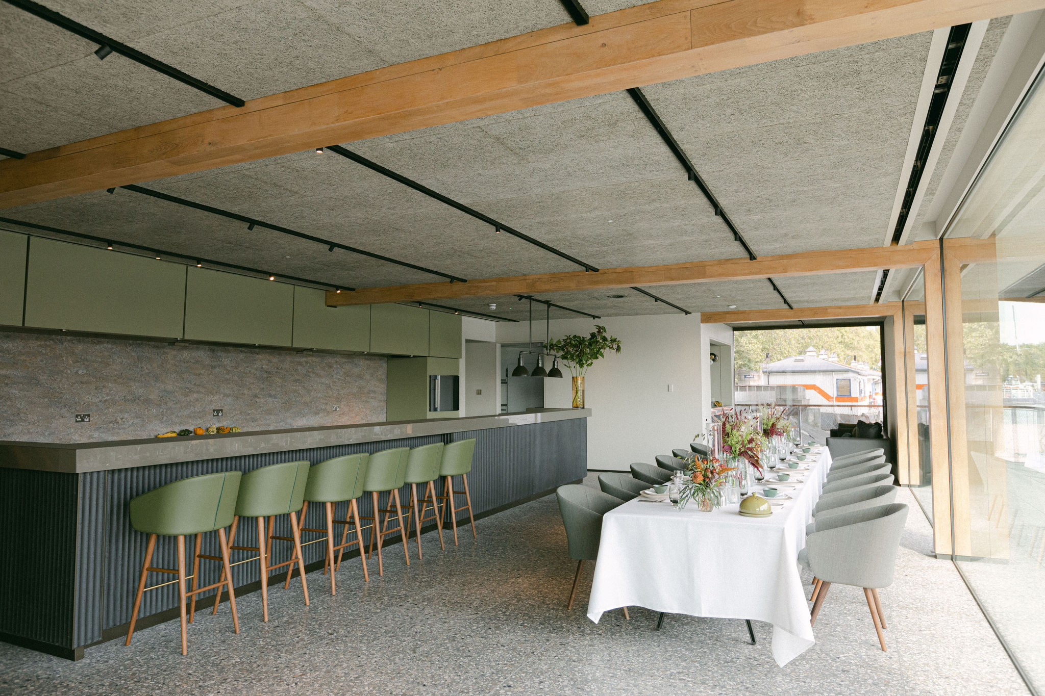 Elegant Woods Quay event space with long dining table, perfect for upscale gatherings.