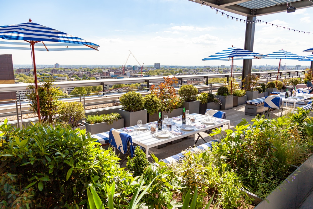 Skylark Rooftop Bar with striped umbrellas, ideal for outdoor events and gatherings.