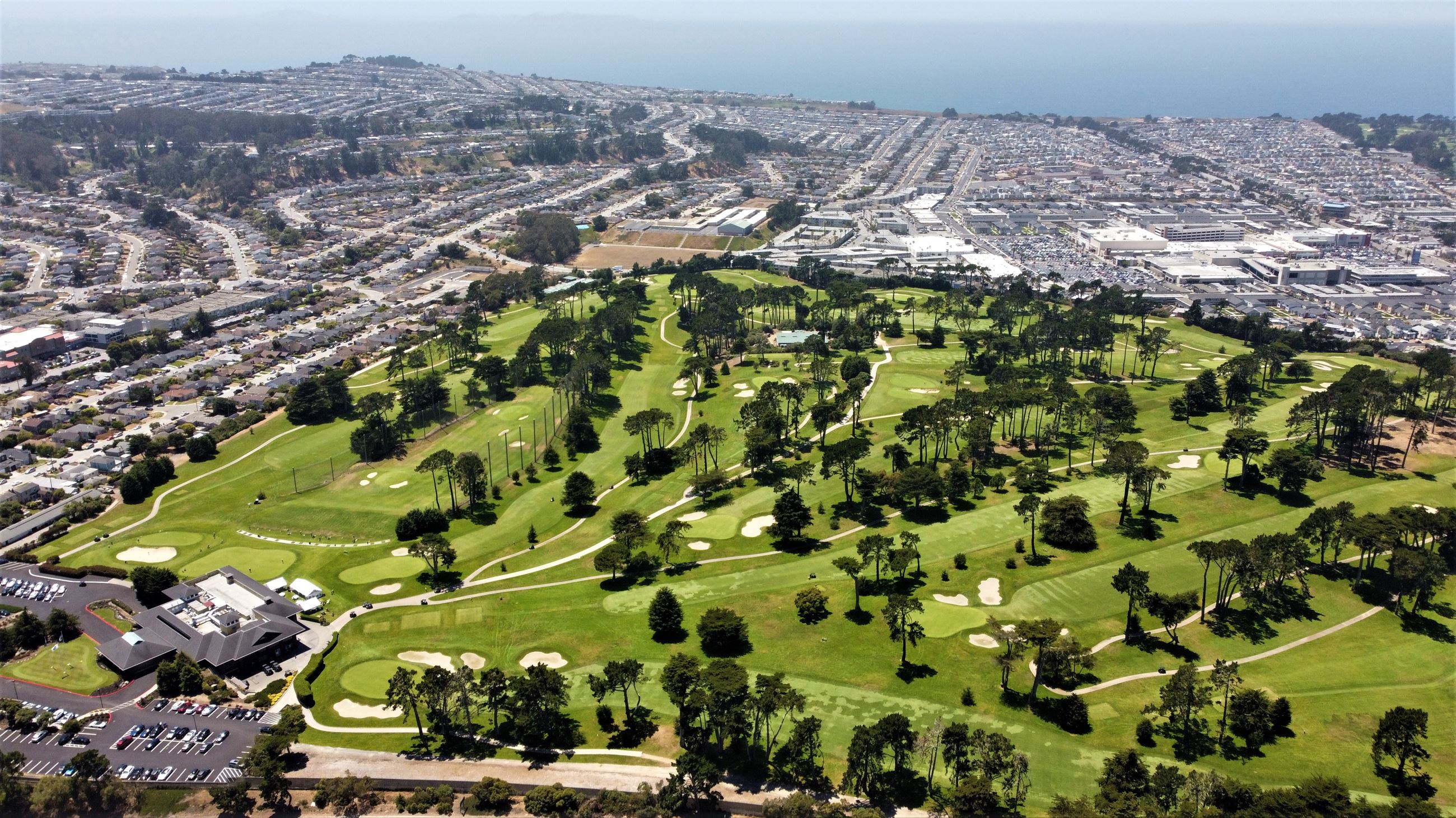 Aerial view of a lush golf course in Daly City, ideal for outdoor events and retreats.
