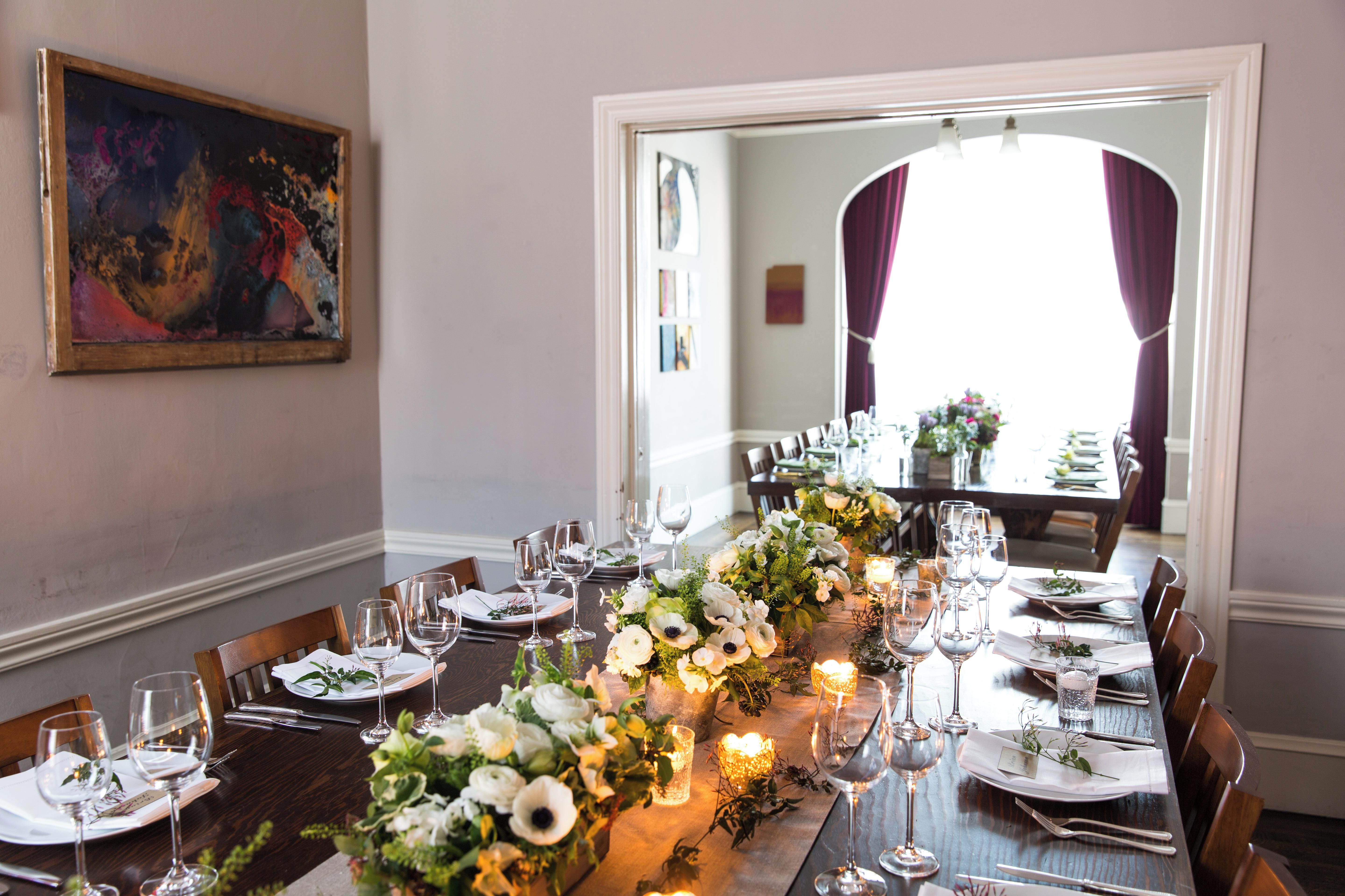 Elegant outdoor dining setup with floral centerpiece for intimate gatherings and corporate events.