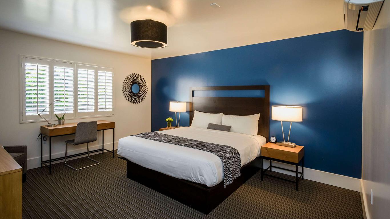 Modern hotel room at Beck's Motor Lodge with blue accent wall for event attendees.