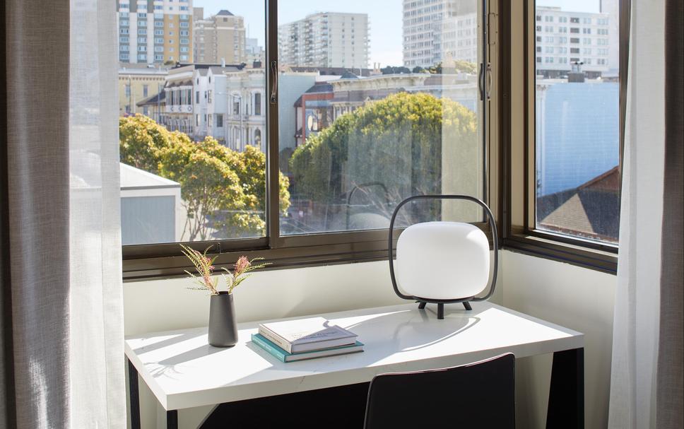 Modern hotel lobby lounge with city view, perfect for meetings and productivity.