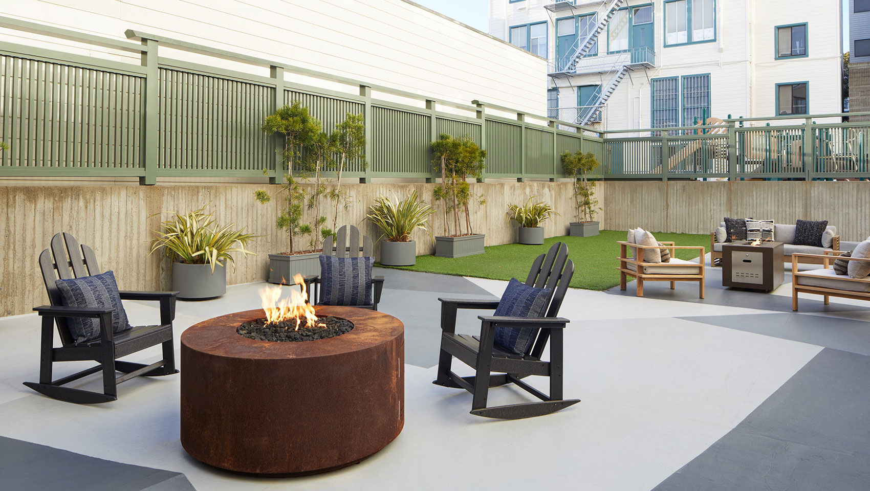 Stylish outdoor lounge with fire pit at Kimpton Hotel Enso for networking events.