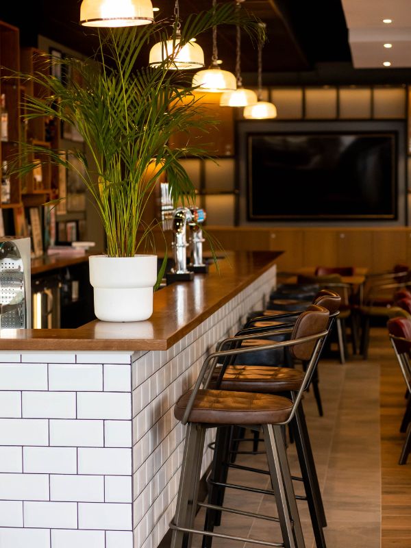 Stylish W Bar with wooden countertop, ideal for networking events and casual meetings.