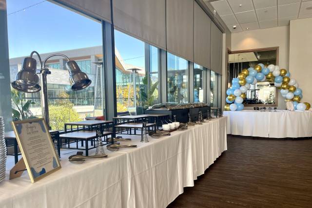 Starboard Room event space with buffet setup, elegant decor, and festive balloon arch.
