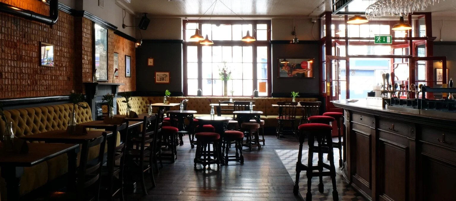 Cozy studio venue with warm lighting for intimate gatherings and casual meetings.