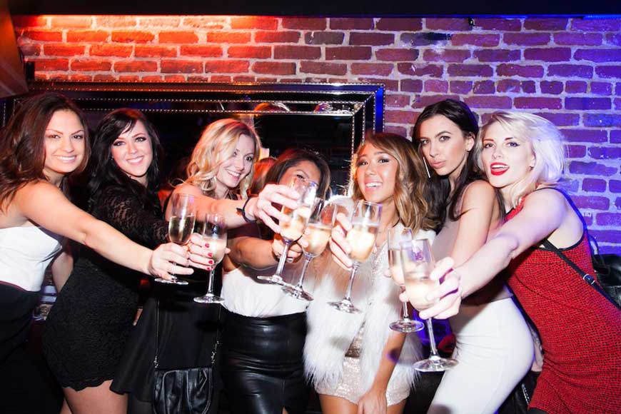 Stylish women toasting champagne in vibrant Hawthorn SF Nightclub for social gatherings.
