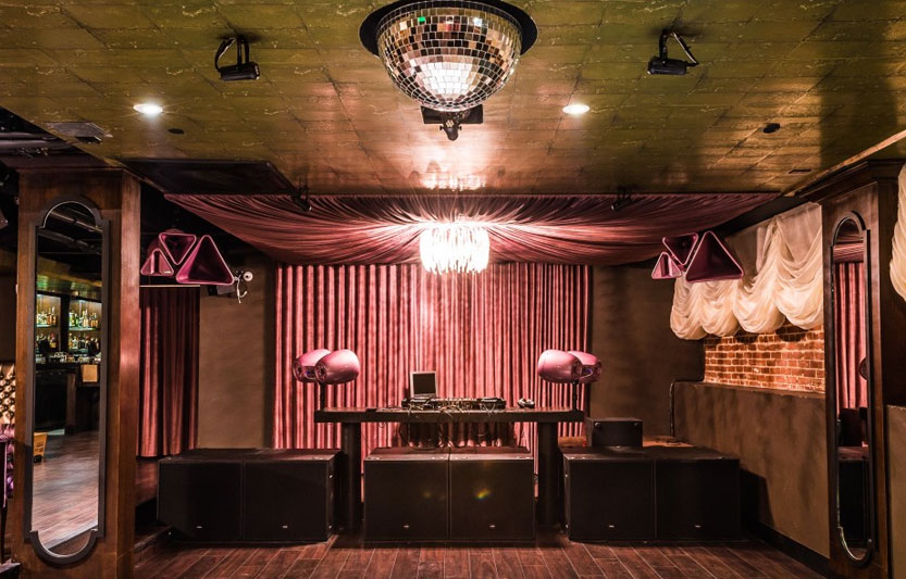 Stylish Hawthorn SF nightclub lounge with DJ booth, ideal for nightlife events and parties.