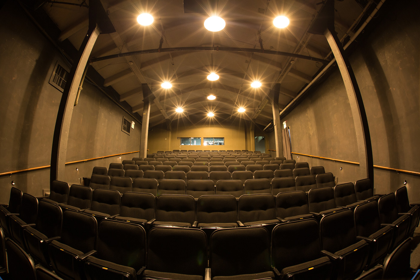 Spacious auditorium with black seating, ideal for conferences and performances at Fort Mason.