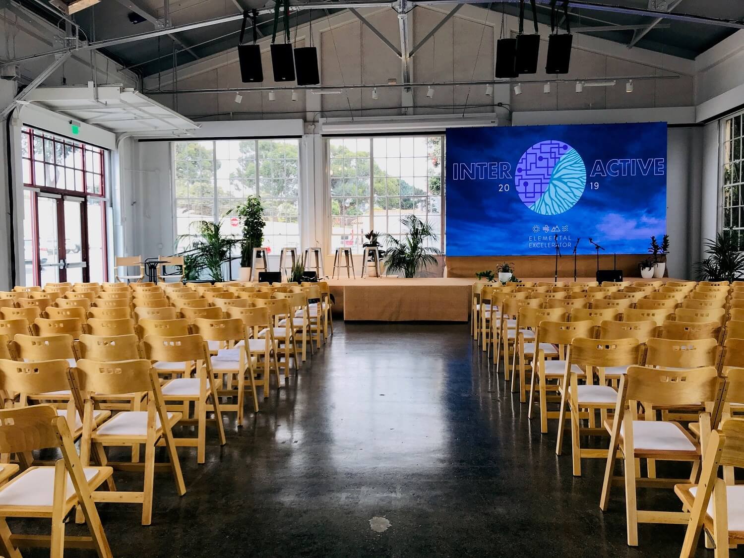 Landmark Building C event space with wooden chairs, ideal for presentations and discussions.