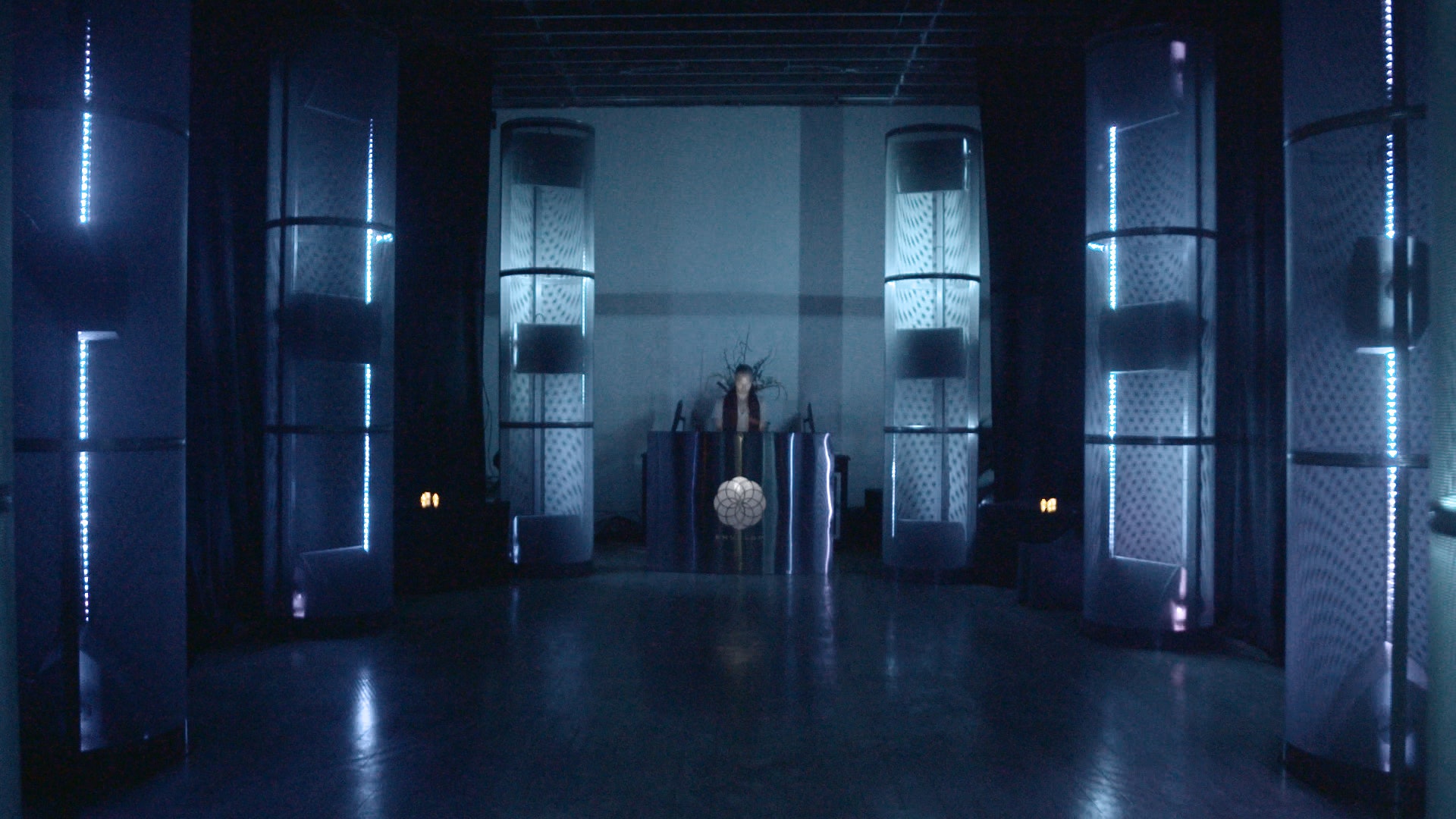 Sleek modern event space with illuminated structures for tech launches and immersive experiences.