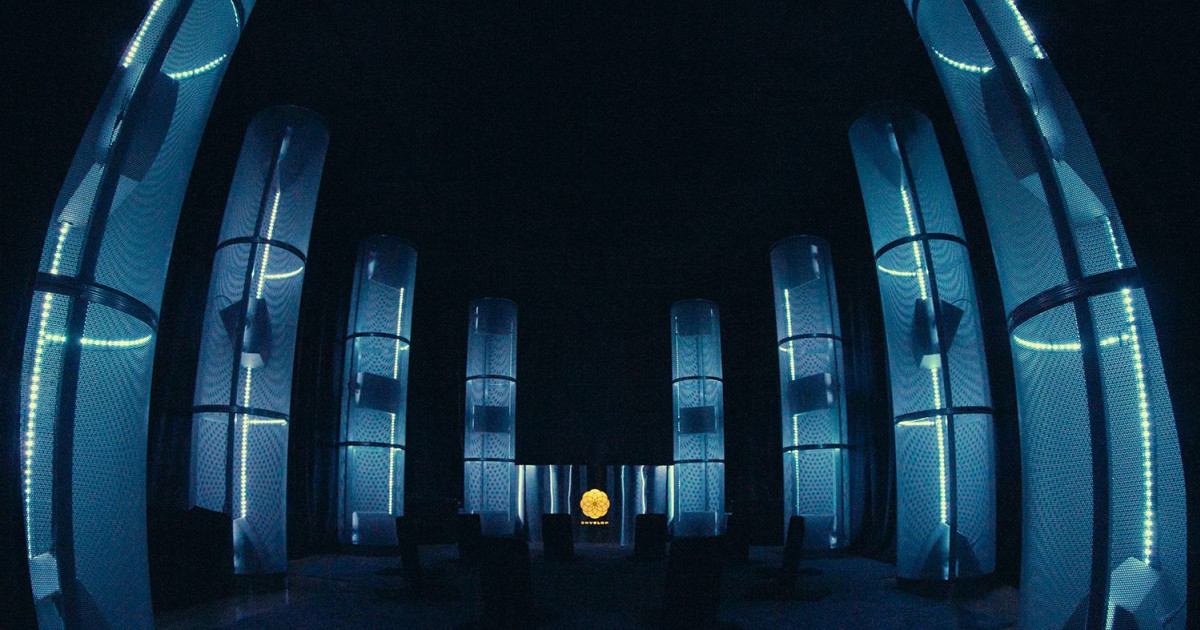 Modern event space with illuminated cylinders, perfect for networking and presentations.