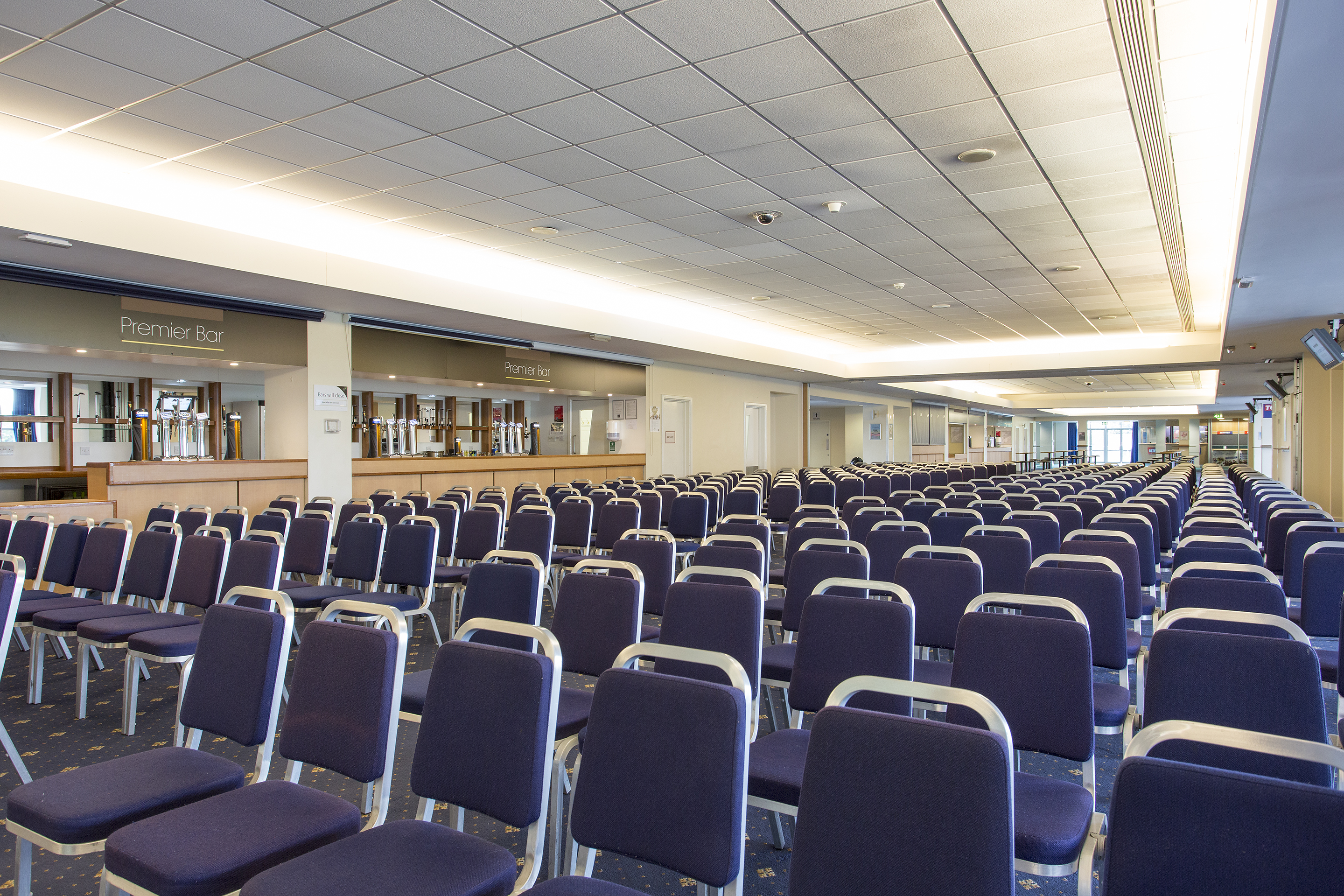 Premier Suite at Kempton Park Racecourse with purple chairs for conferences and seminars.