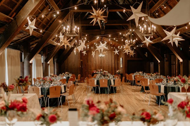 Outdoor Art Club courtyard with round tables, elegant centerpieces for weddings and events.