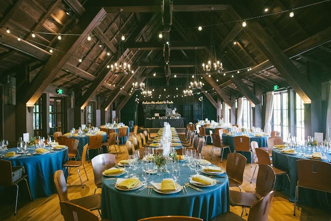 Elegant outdoor event space with blue tablecloths, ideal for weddings and corporate gatherings.