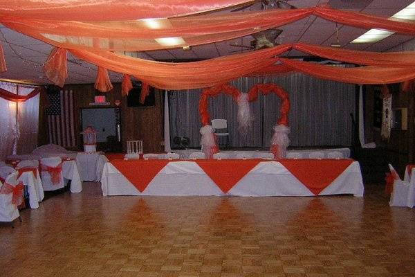 Elegant banquet hall with heart-shaped backdrop, perfect for weddings and anniversaries.
