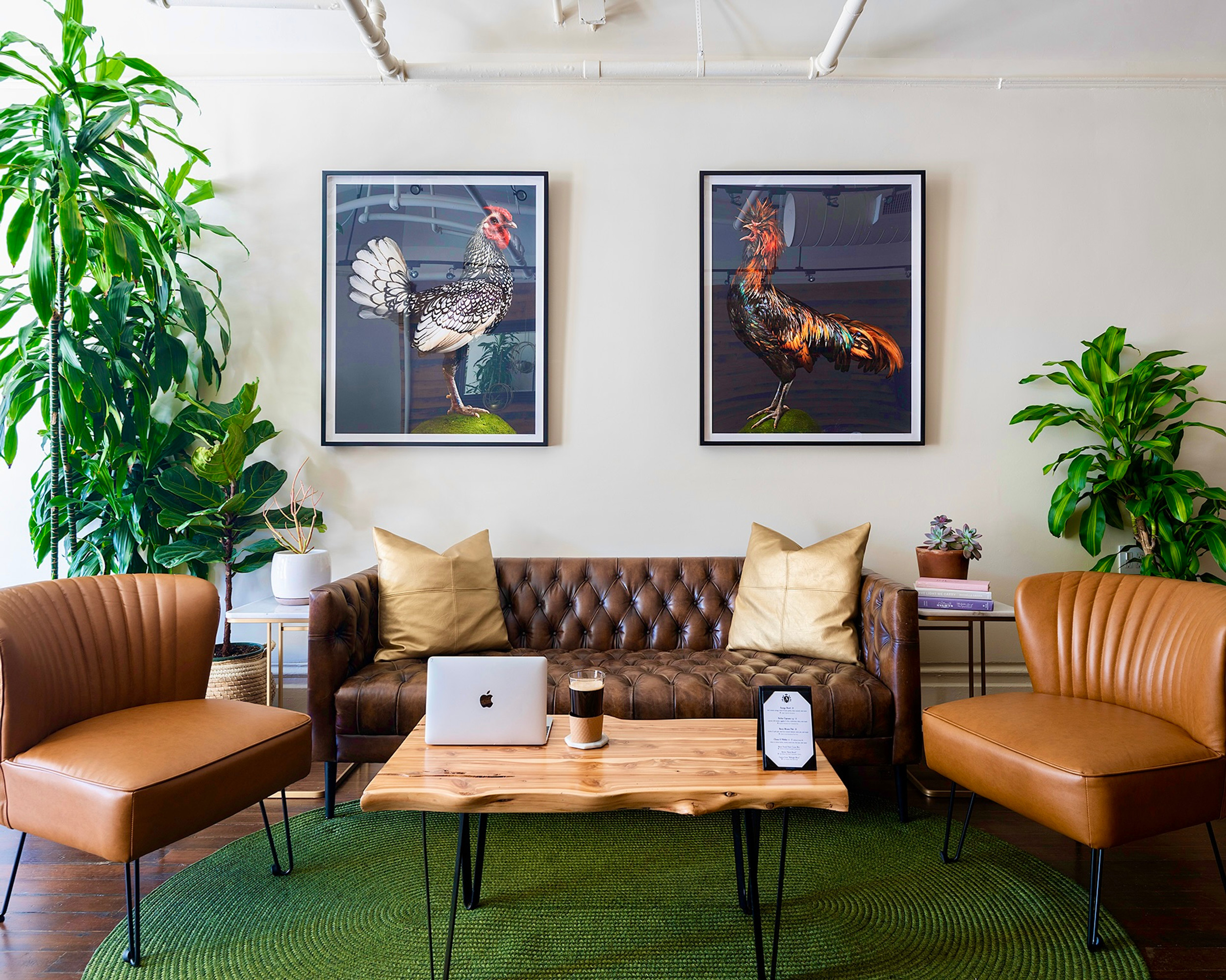 Stylish meeting space with leather sofa and modern chairs for creative gatherings.