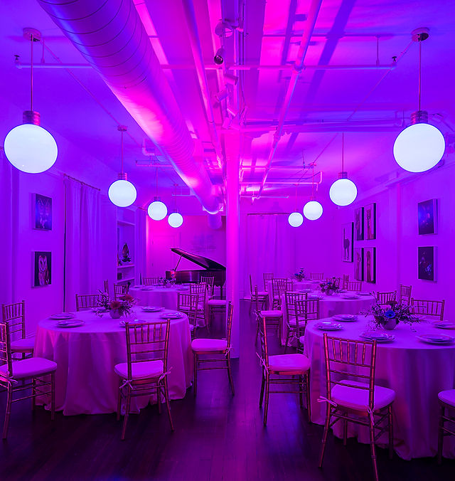 Stylish lounge with round tables and purple lighting for upscale events in The Academy SF.