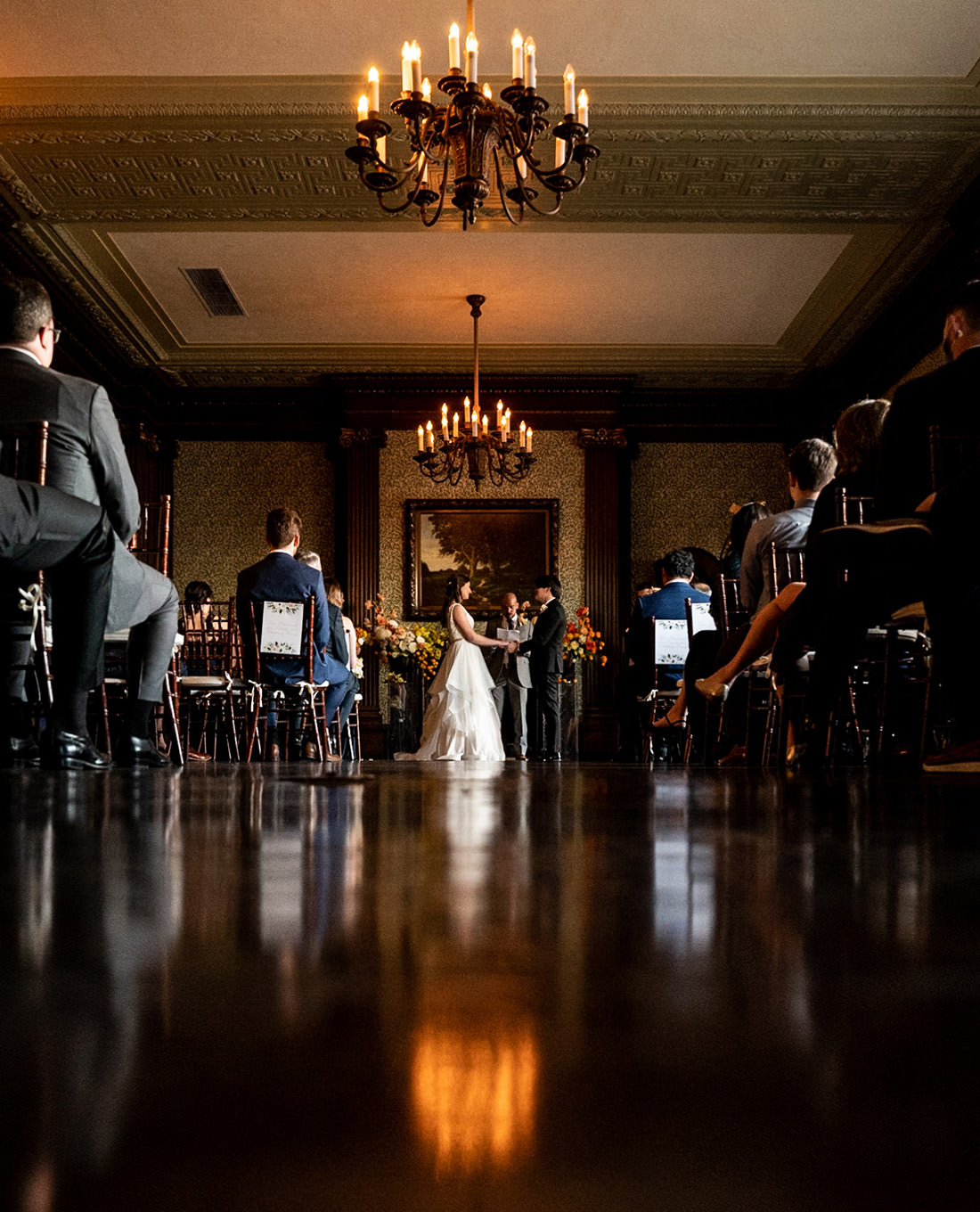 Elegant wedding ceremony at University Club of San Francisco with warm lighting.