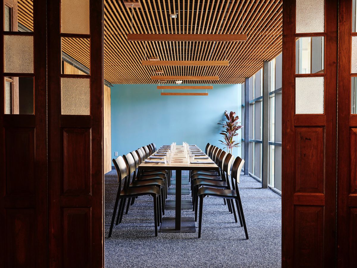 Private dining room with long table, ideal for workshops and meetings.